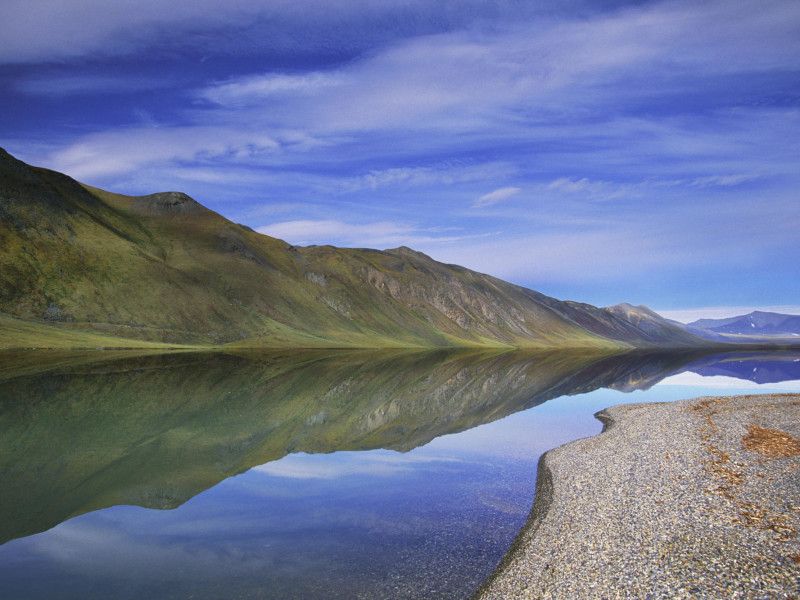 An Extremely Rare, Calm Day Brings Almost Perfect Reflections To The Surface Of Lake Peters In Alaska’s Arctic National Wildlife Refuge.